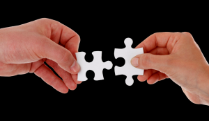 partnering advisor image of two hands putting jigsaw pieces together