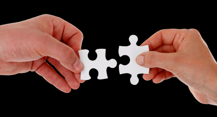 partnering advisor image of two hands putting jigsaw pieces together